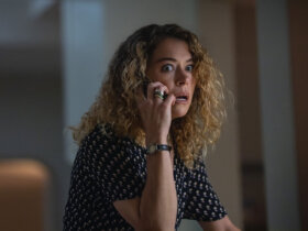 Paula on the phone looking shocked in Maximum Pleasure Guaranteed.