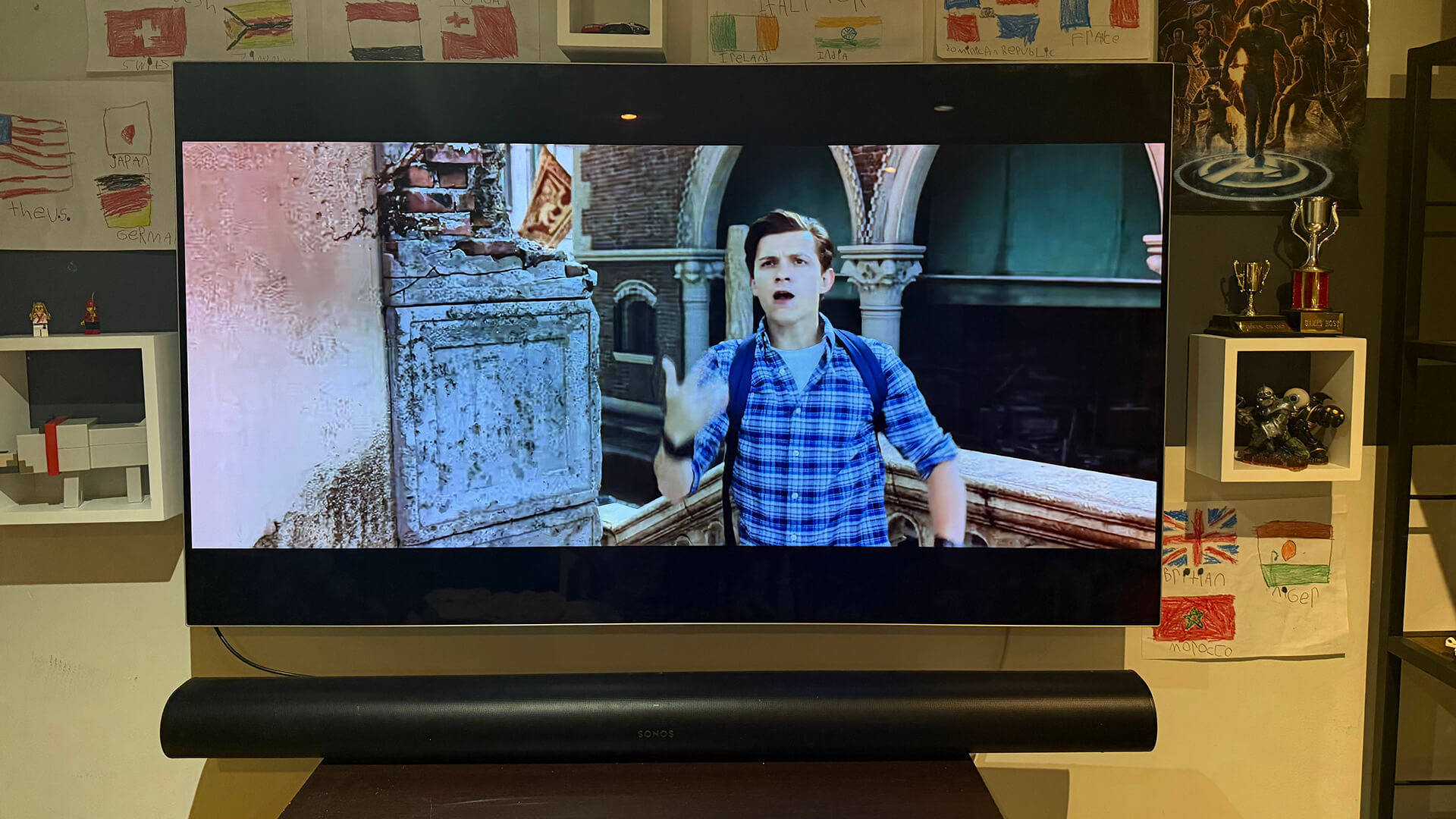 An LG OLED TV with a Sonos Arc soundbar below it
