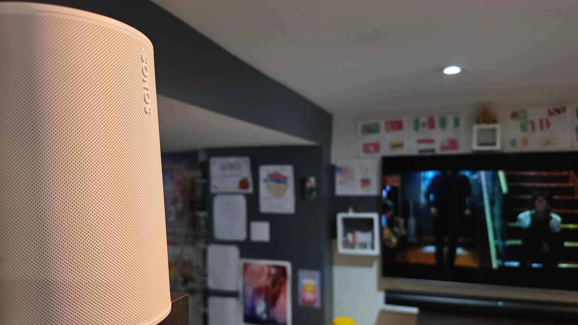 Sonos Era 100 SL on an angle behind a TV