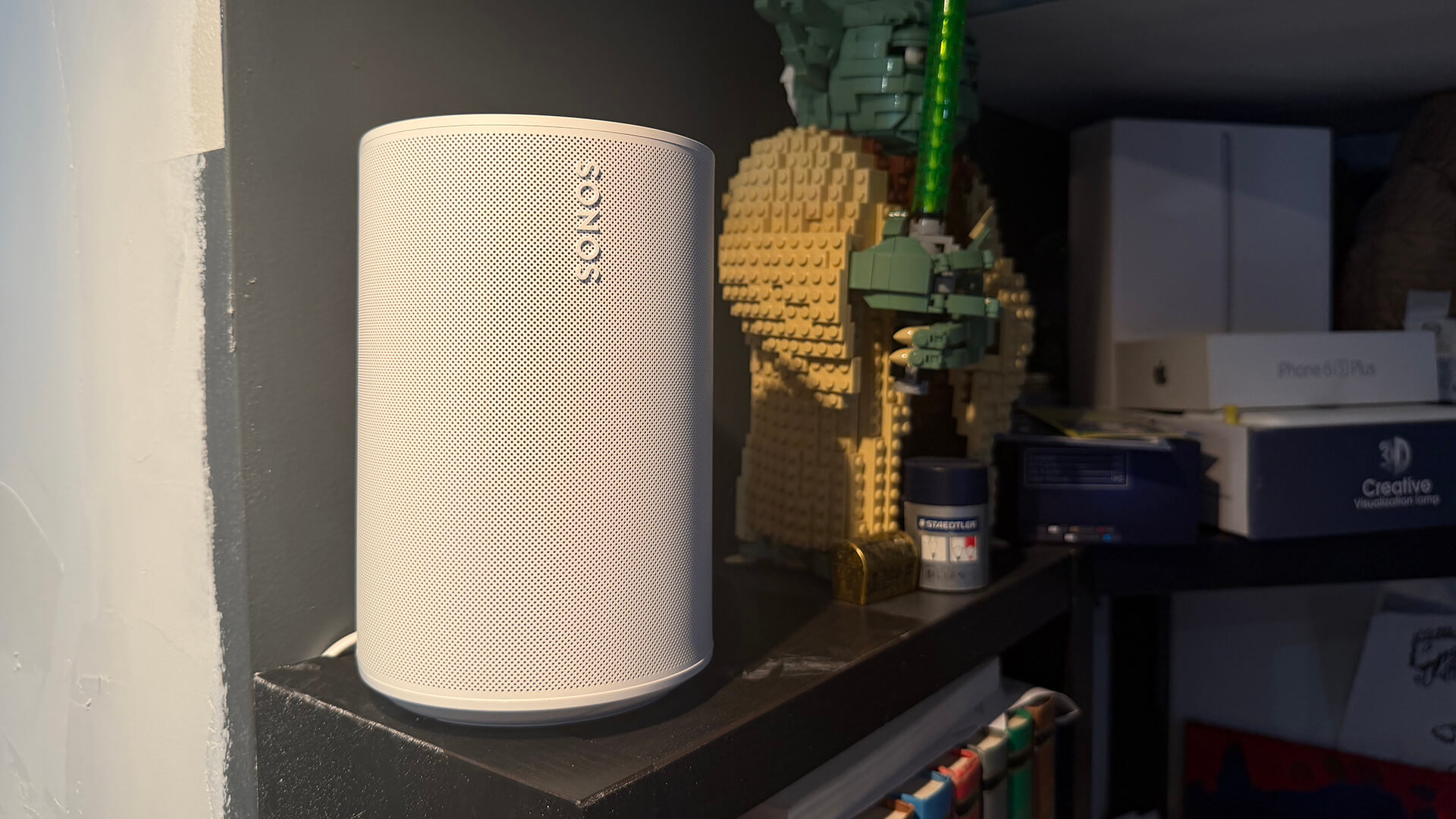 Sonos Era 100 SL on the top of a desk.