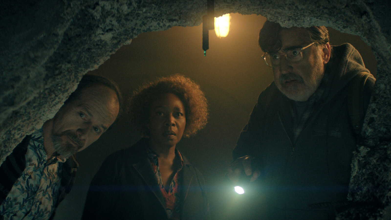 Wally, Judy, and Art looking into a cave in The Boroughs.