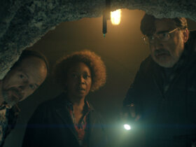 Wally, Judy, and Art looking into a cave in The Boroughs.