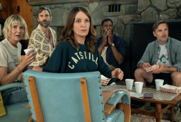 The friends sitting in a hotel lobby looking back at something in The Four Seasons.