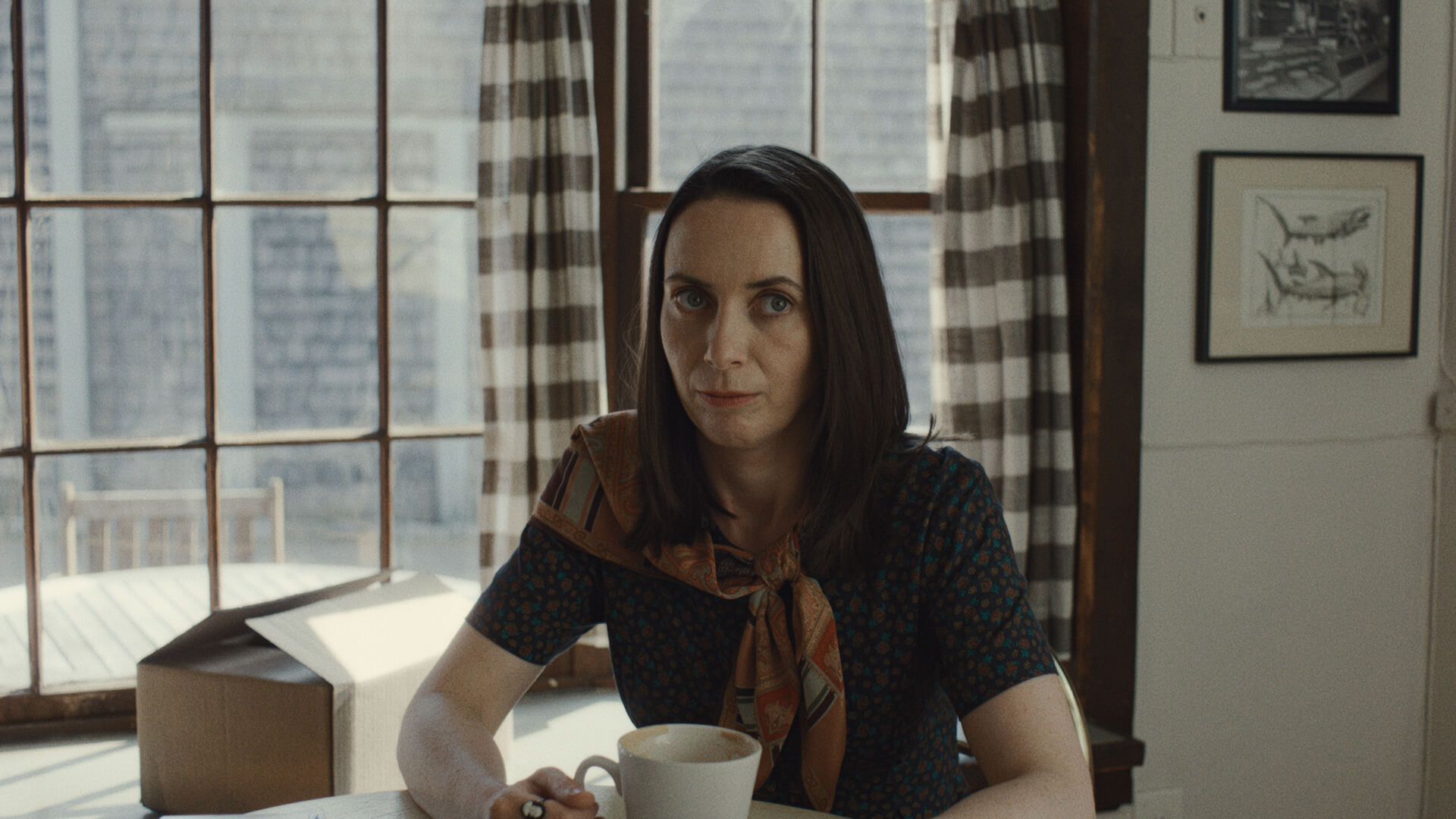 Patricia sitting with a coffee cup in Widow's Bay.