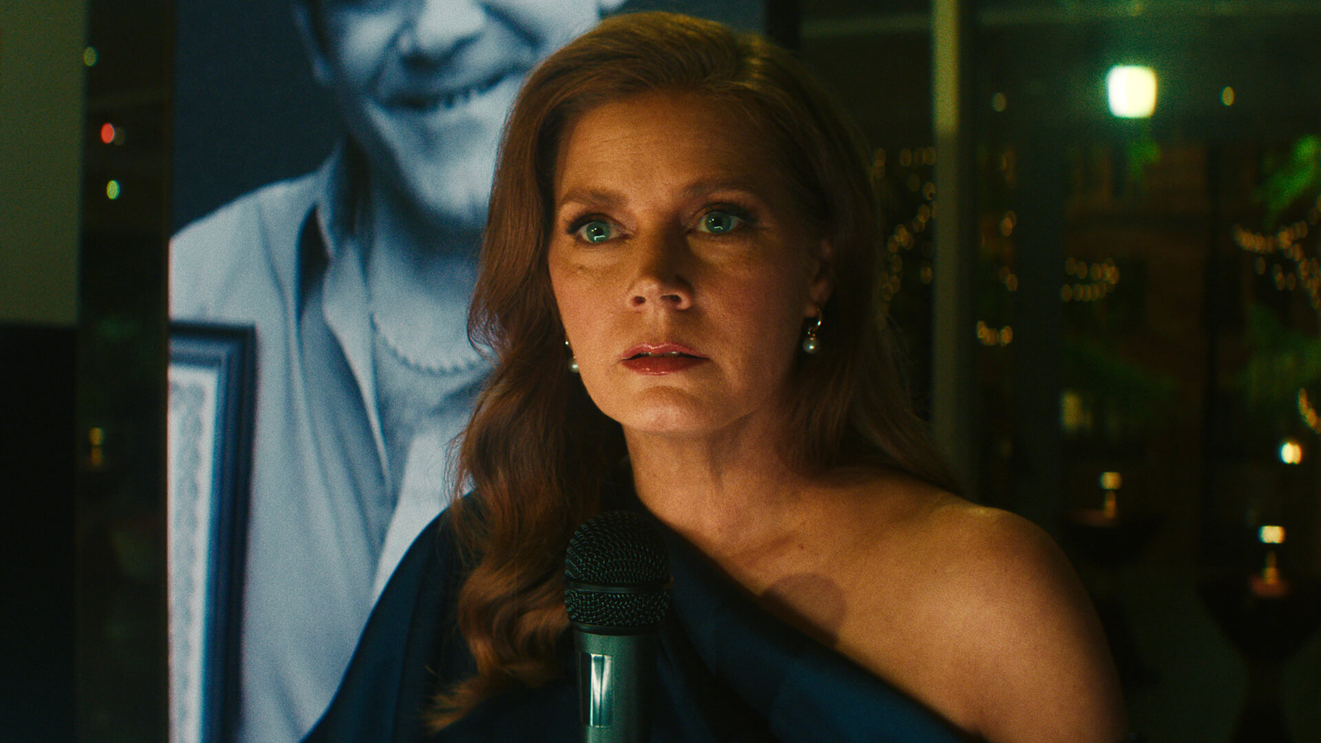 Anna standing behind a microphone looking stunned in Cape Fear.