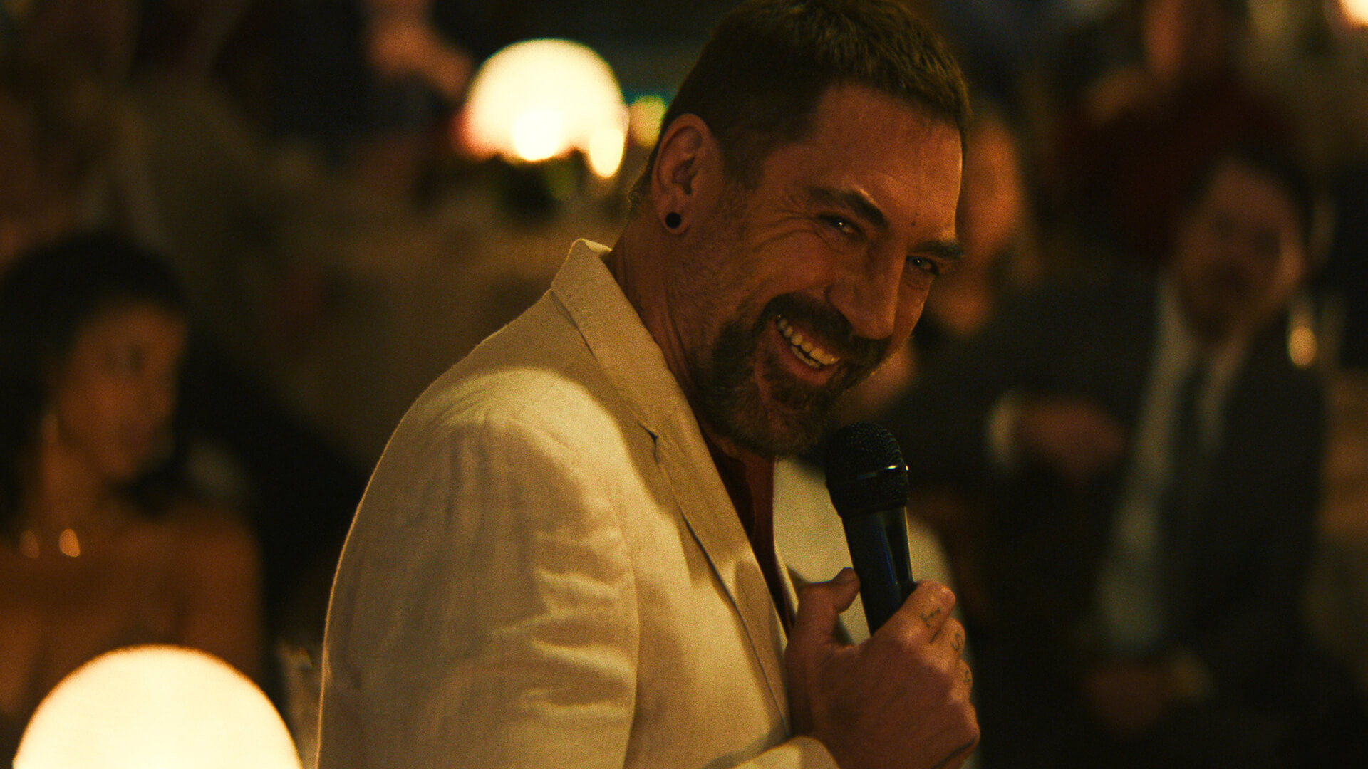 Max holding a microphone and smiling maniacally in Cape Fear.