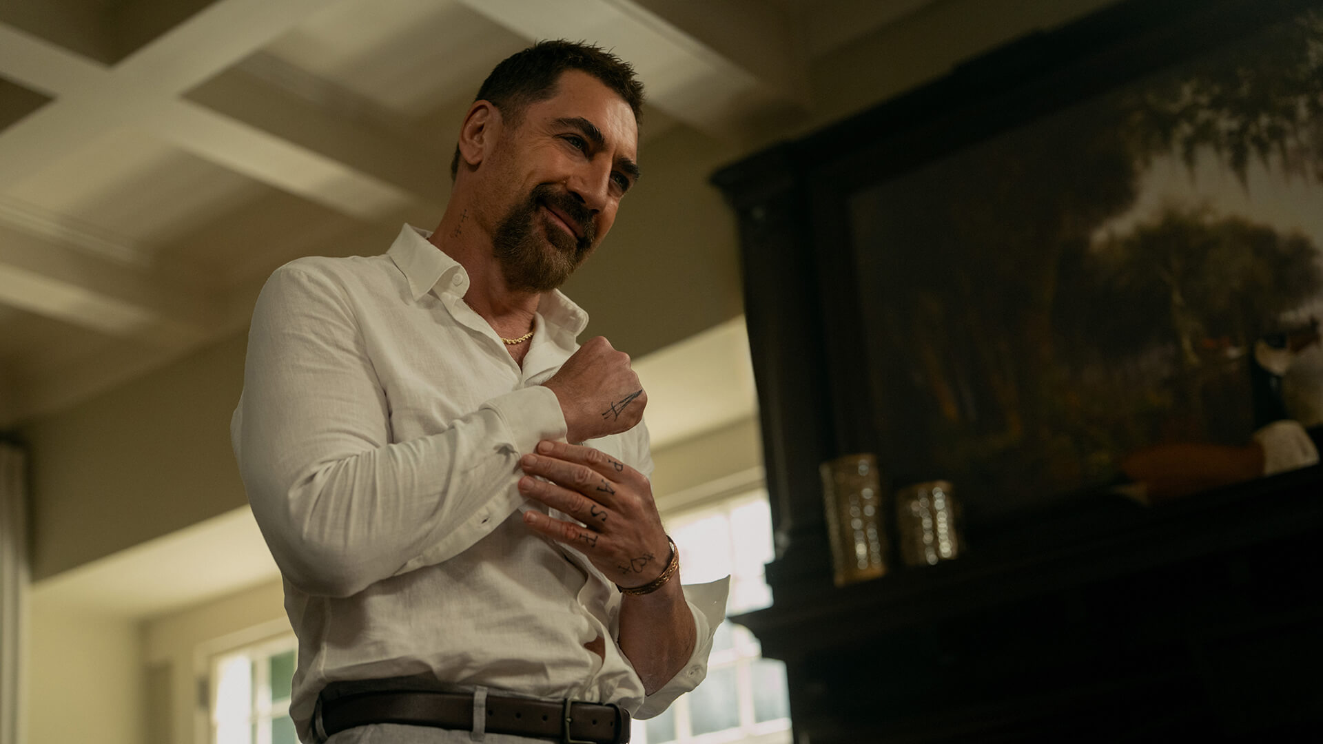 Max fixing the cufflinks on his shirt in Cape Fear.