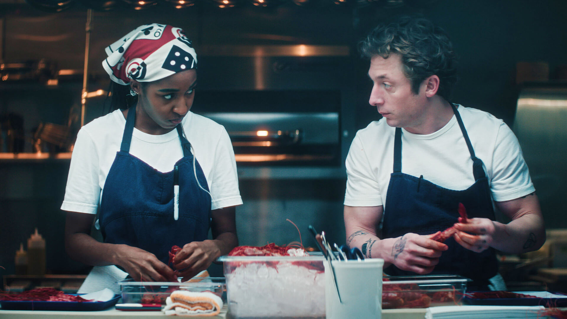 Sydney and Carmy working side by side in the kitchen in The Bear.