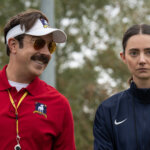 Ted looking at Alice and smiling in Ted Lasso.