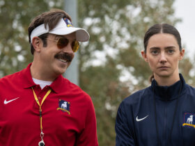 Ted looking at Alice and smiling in Ted Lasso.