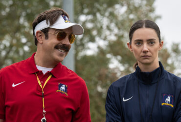 Ted looking at Alice and smiling in Ted Lasso.