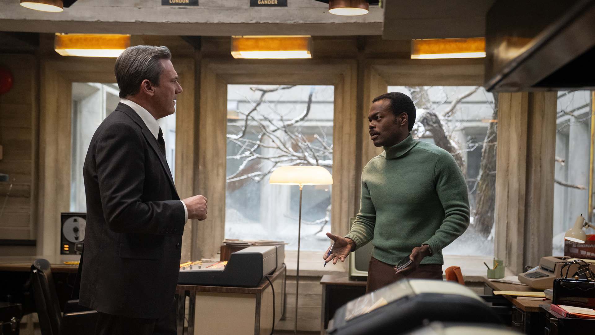 Fred and Ben talking in the office in American Hostage.