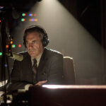 Fred Heckman wearing headphones on the radio in American Hostage.
