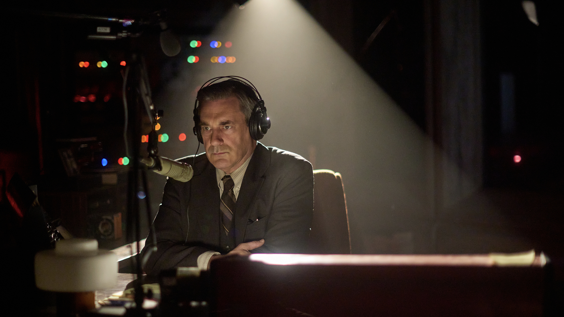 Fred Heckman wearing headphones on the radio in American Hostage.