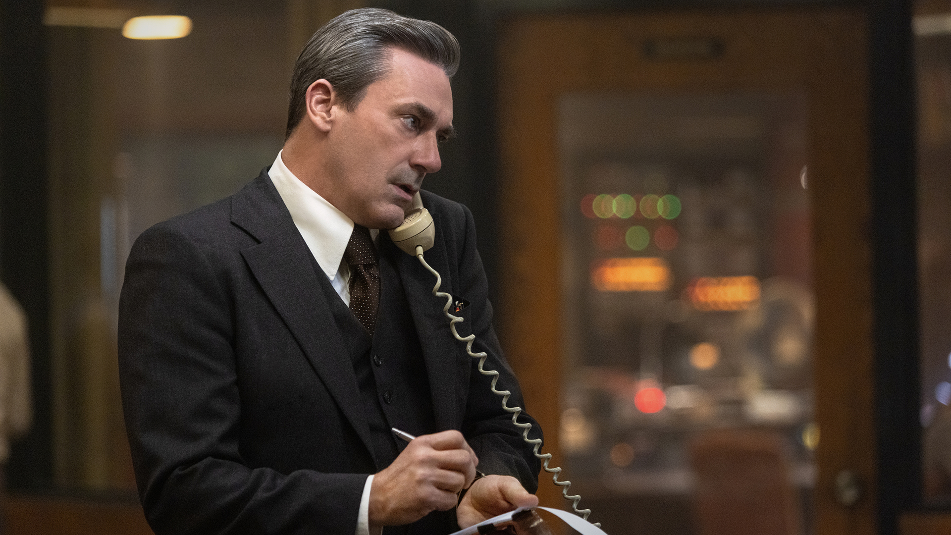 Fred on the phone while taking notes in American Hostage.
