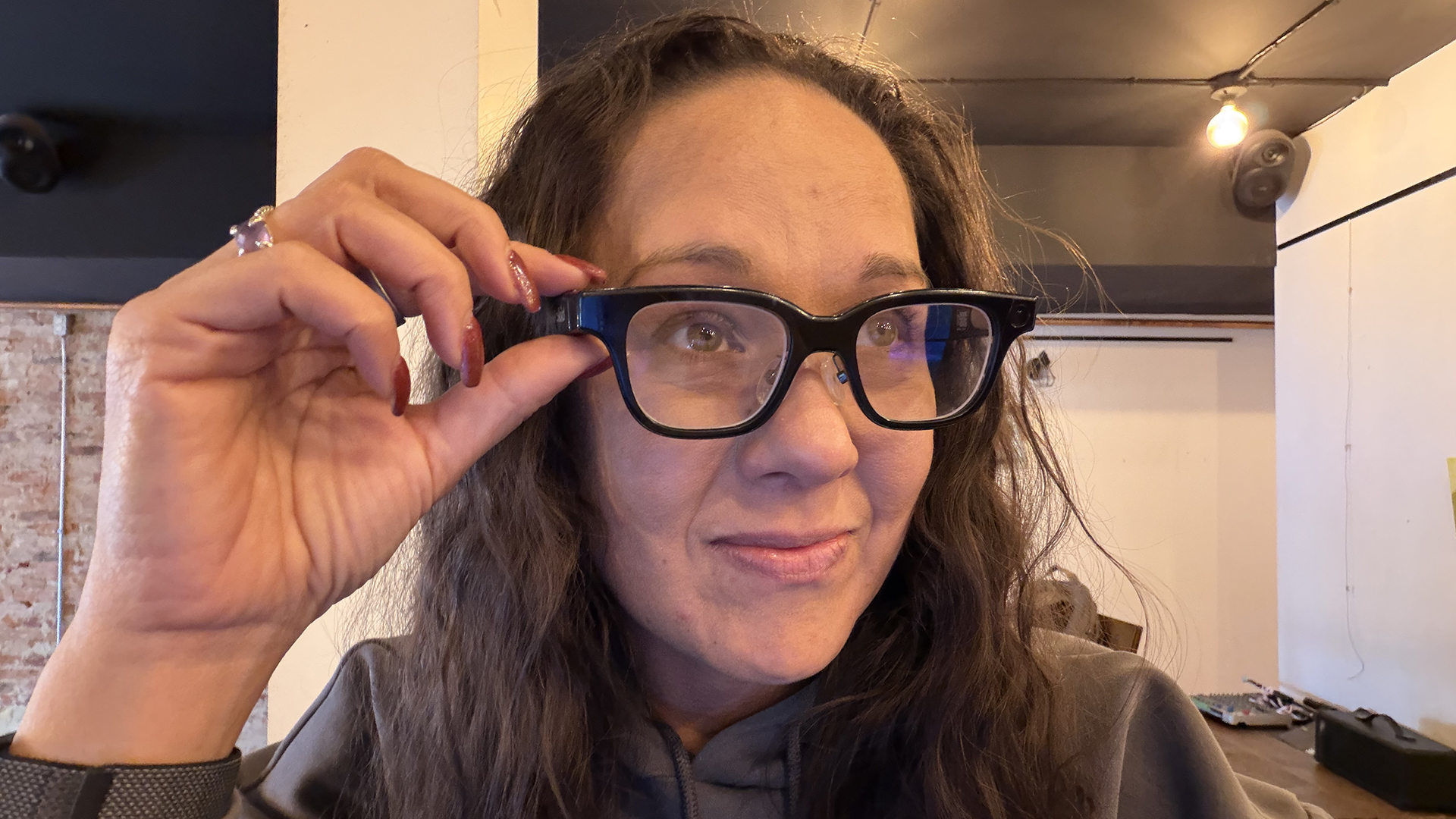 A woman wearing the Rokid glasses in a coffee shop