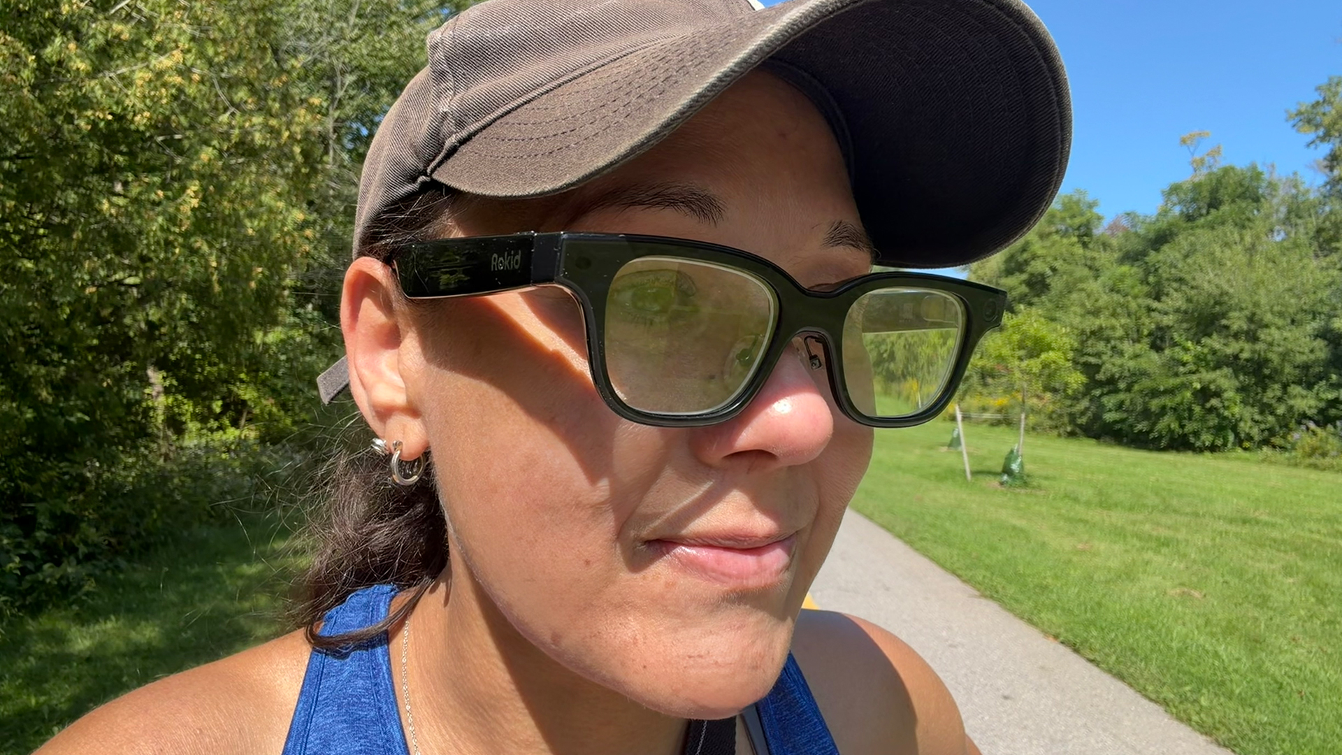 A woman wearing the Rokid smart glasses outside.