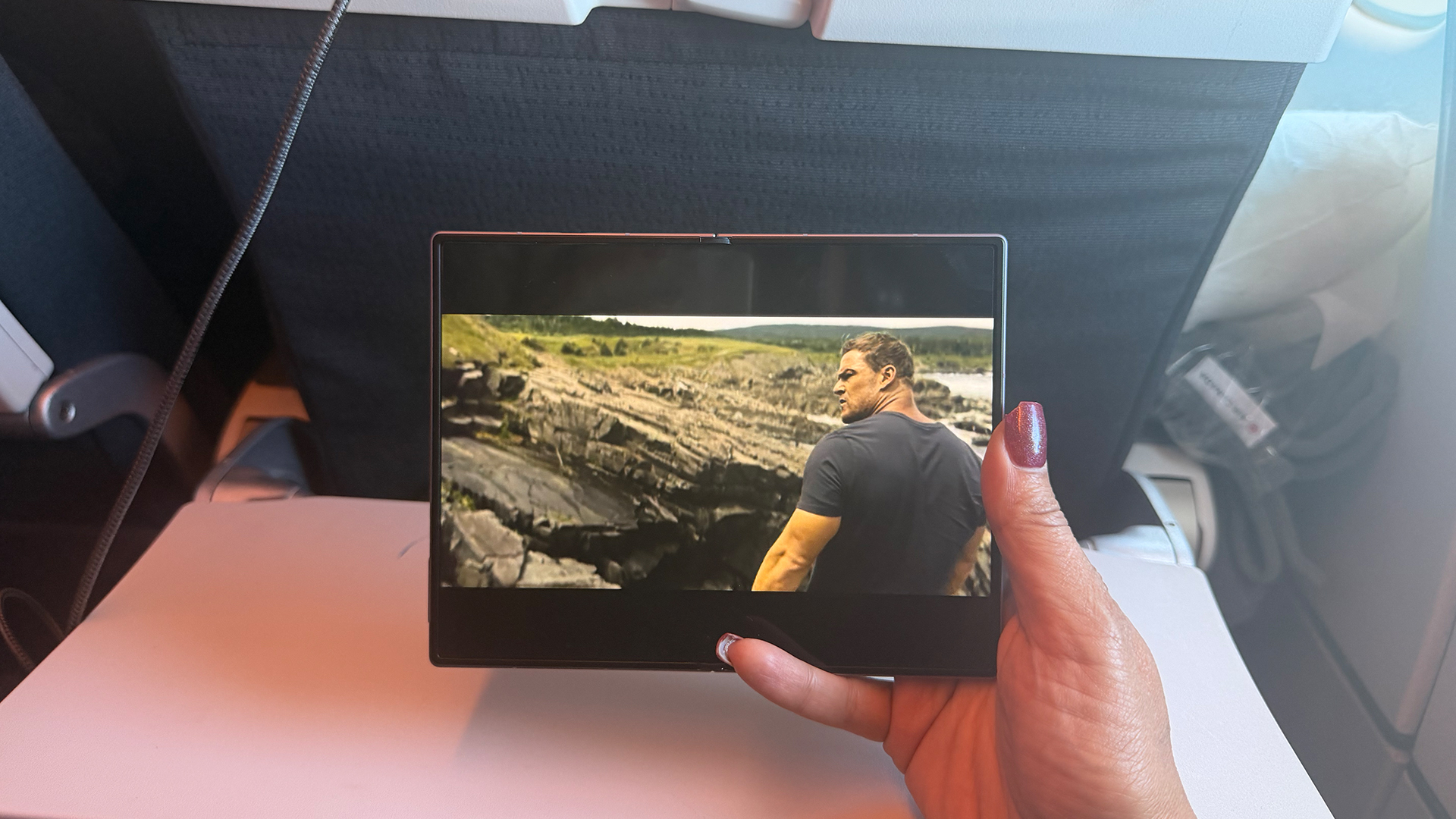Samsung Galaxy Z Fold 8 open watching video on plane