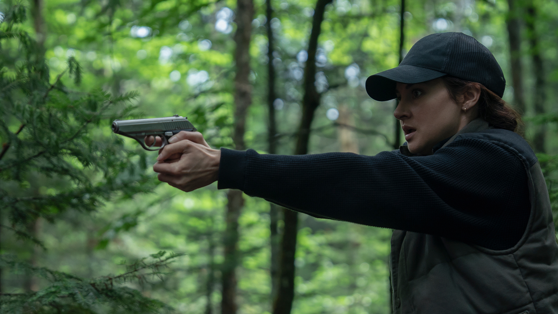 Joanne in the woods with a gun in Unabomber.