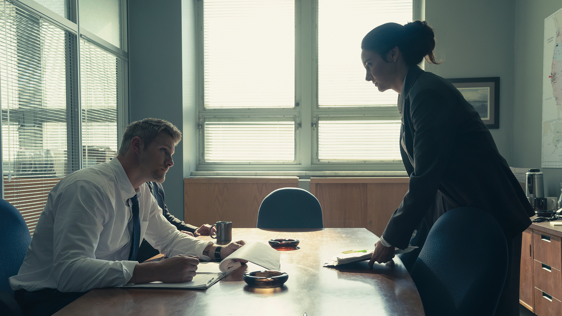 Joanne talking to a man in the office in Unabomber.