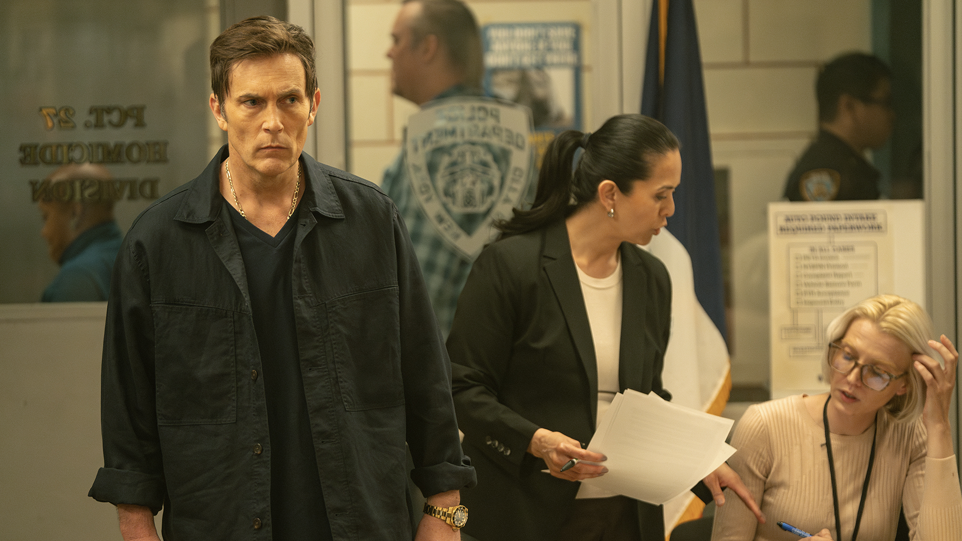 Joey walking through the police station in Dexter: Resurrection.